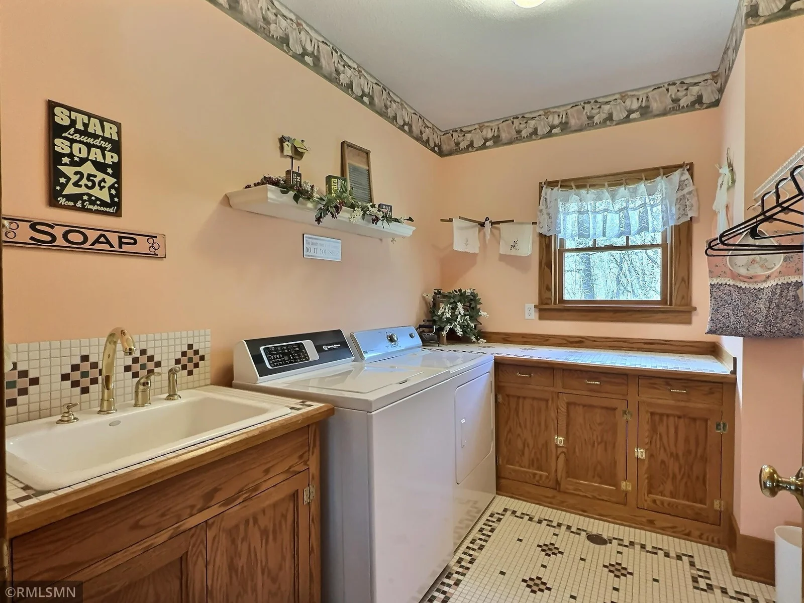 Laundry room is spacious, utility sink, hanging space, and tiled floors have in floor heat.