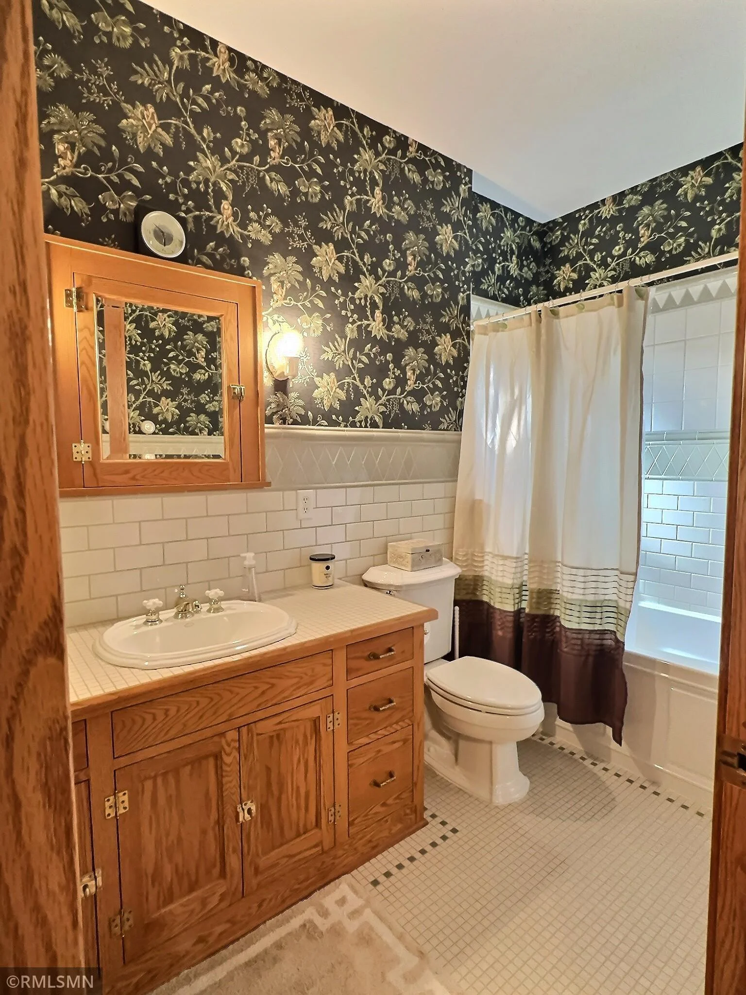 Upper bathroom with custom cabinetry and tile.