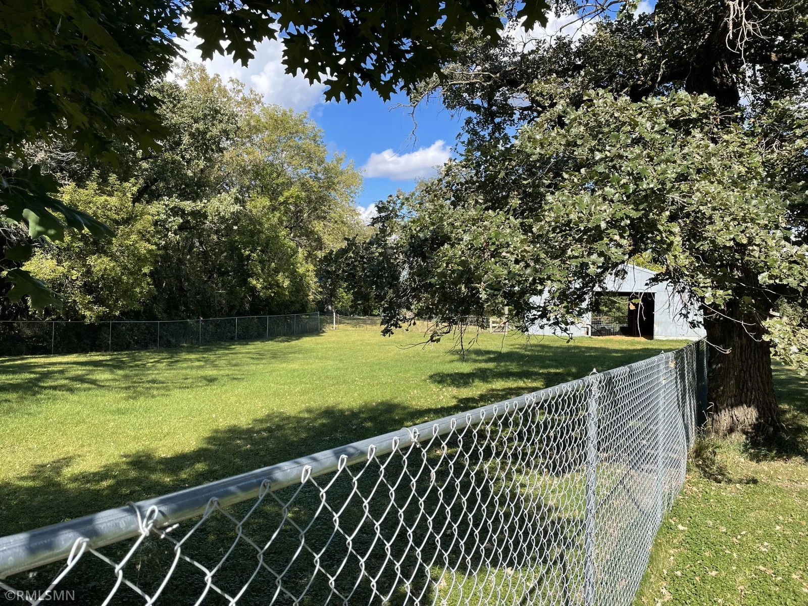 Fenced in area that comes off of the pole building.
