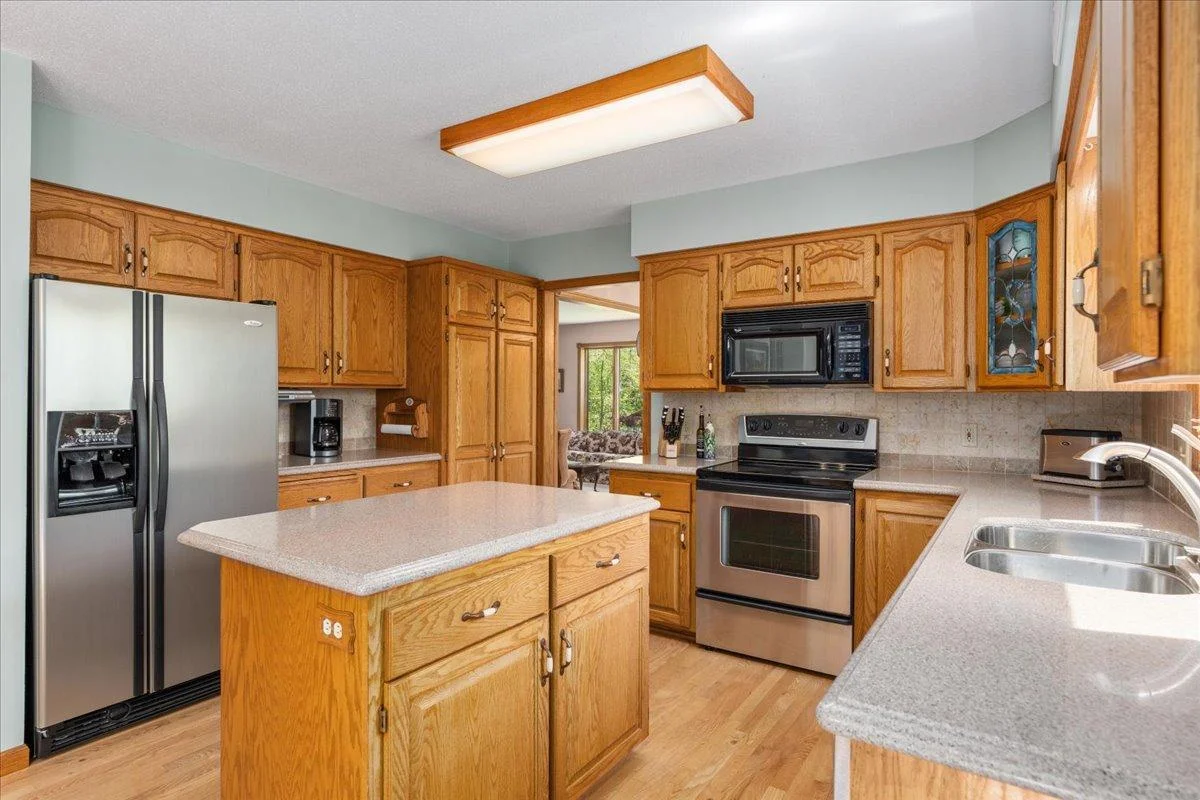 The kitchen has plenty of storage, oak hardwood floors and stainless steel appliances