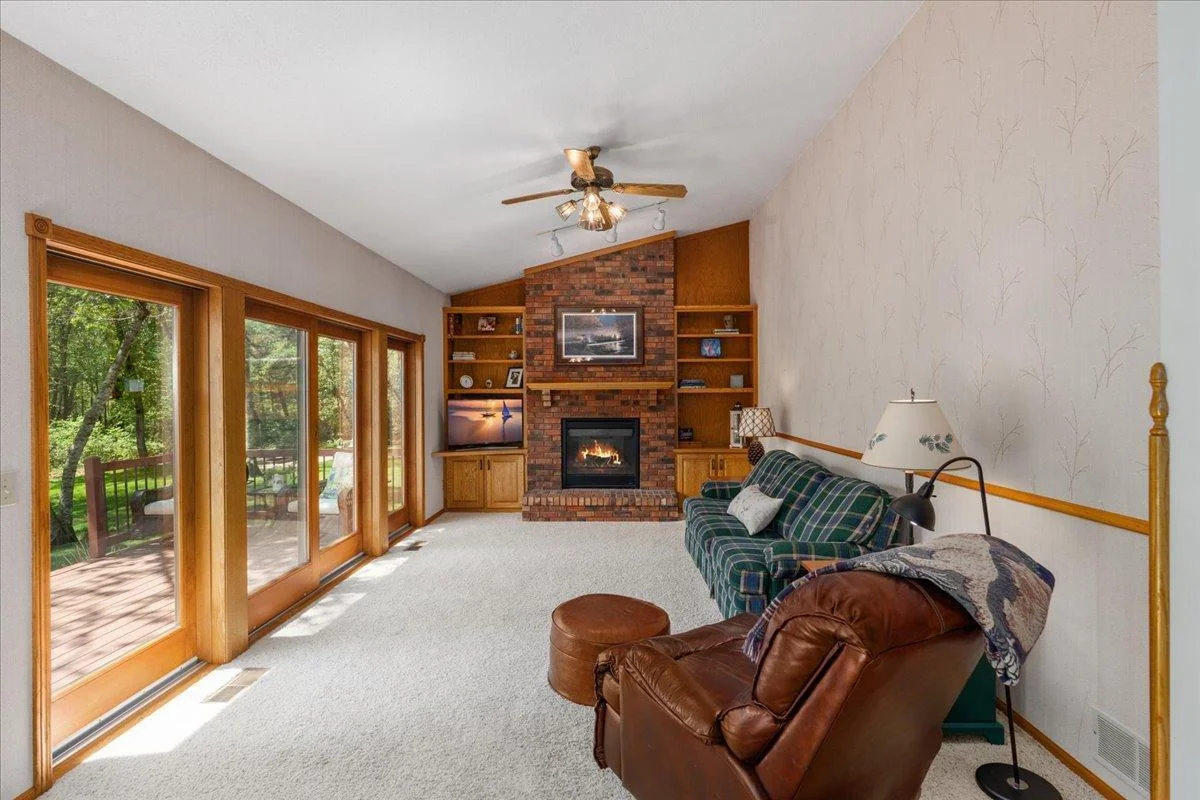 Great room with vaulted ceiling and a cozy floor to ceiling brick gas fireplace