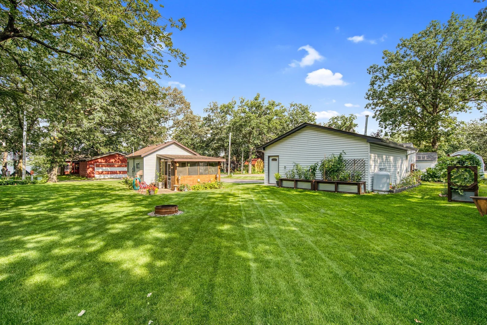 Lot across the street with the bunk house and detached garage.