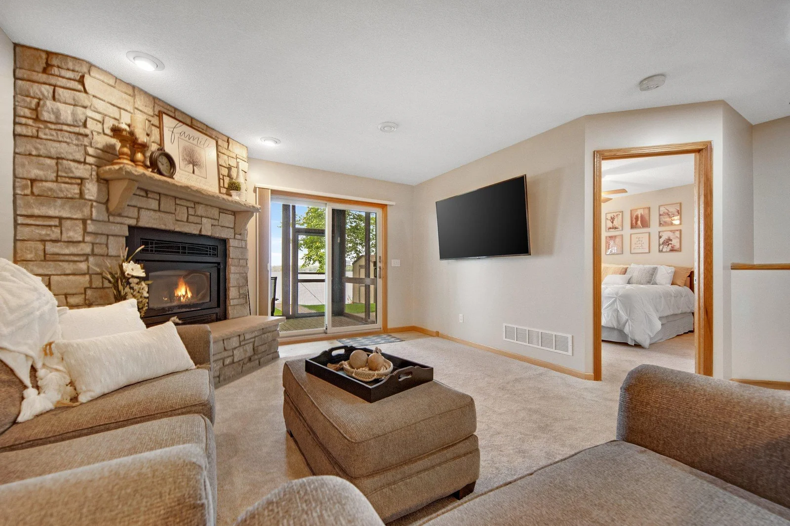 Lower level with stunning floor to ceiling stone gas fireplace. Easy walkout to the lower level patio too!