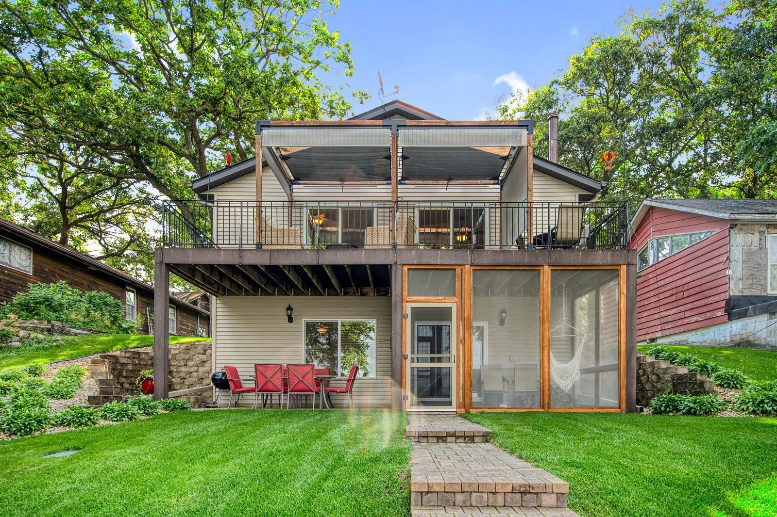 Walkout lower level with screened-in patio, paver patio, and maintenance-free deck on top.
