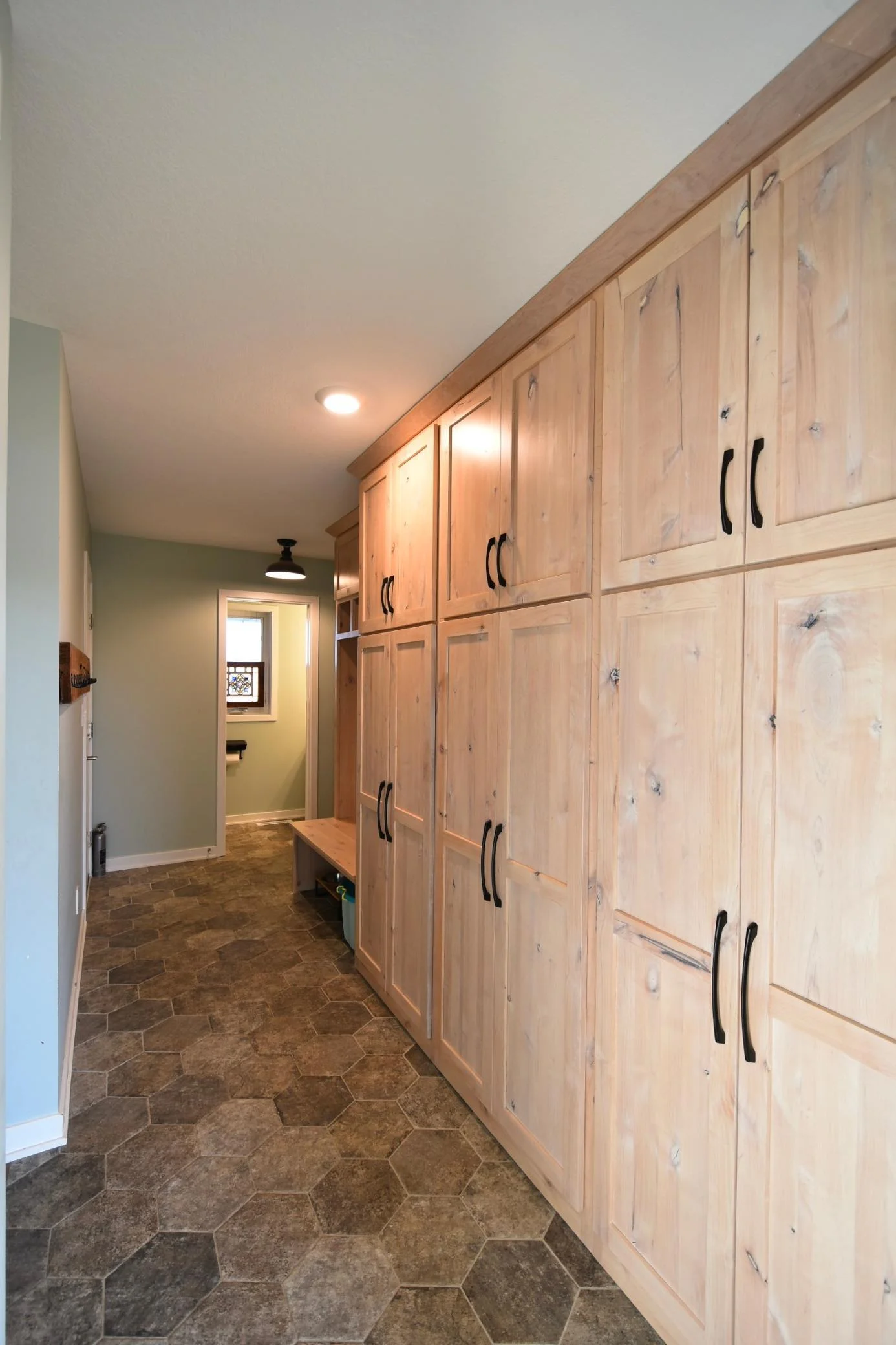 Mudroom with tile flooring & custom cabinets/built-ins