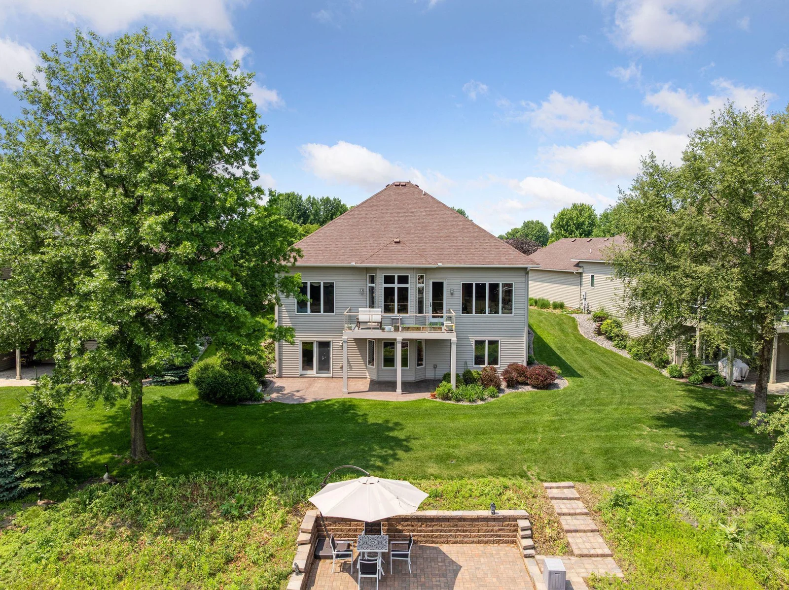 Back of home has both Deck & lake side Patio