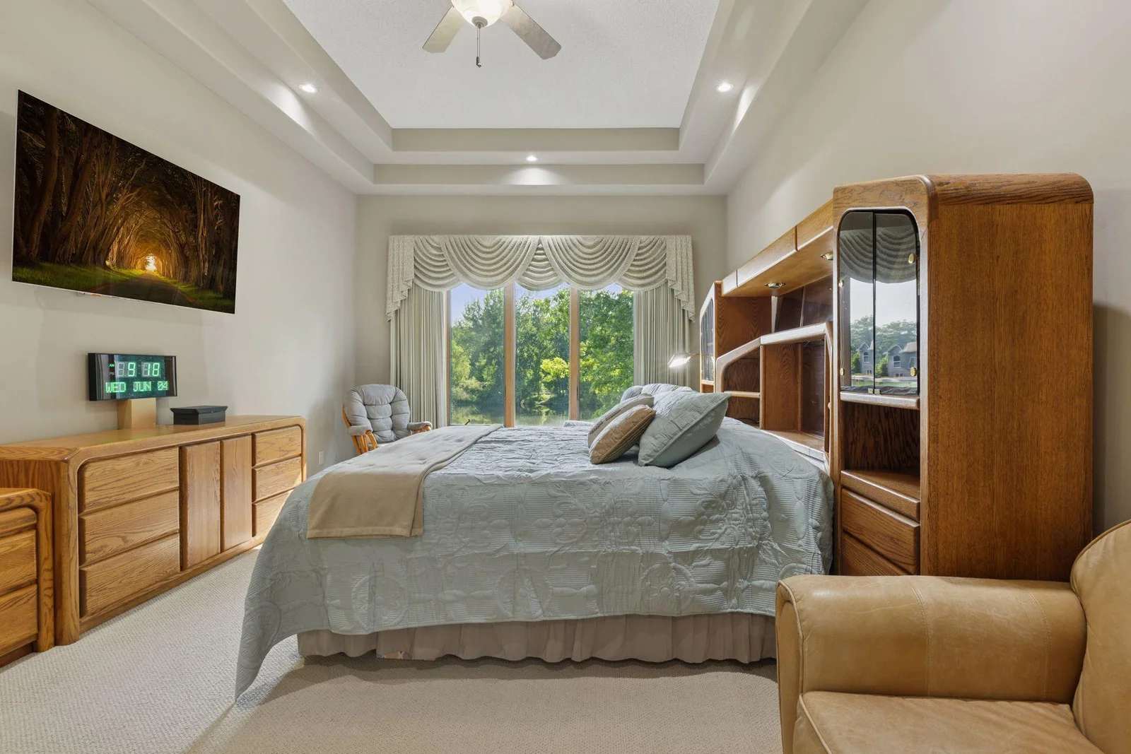 Primary bedroom has gorgeous, high ceiling & large windows