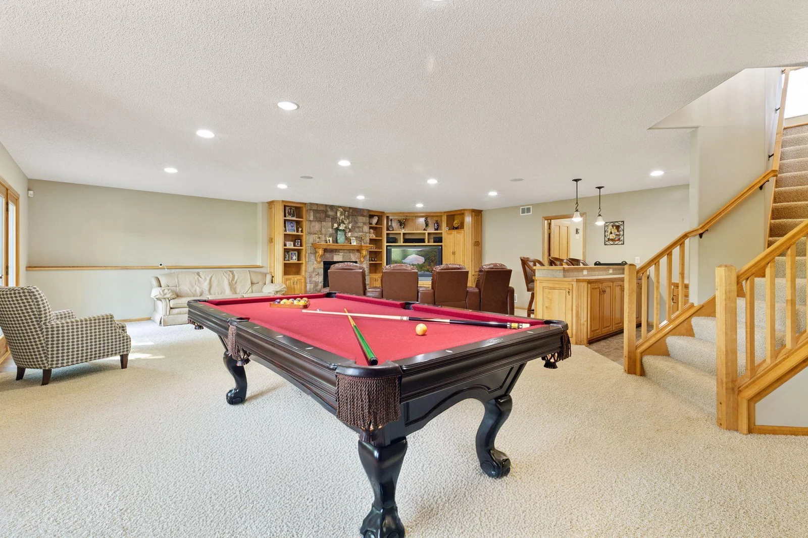 Large, LL FR with gas fireplace, stone surround and built in cabinetry