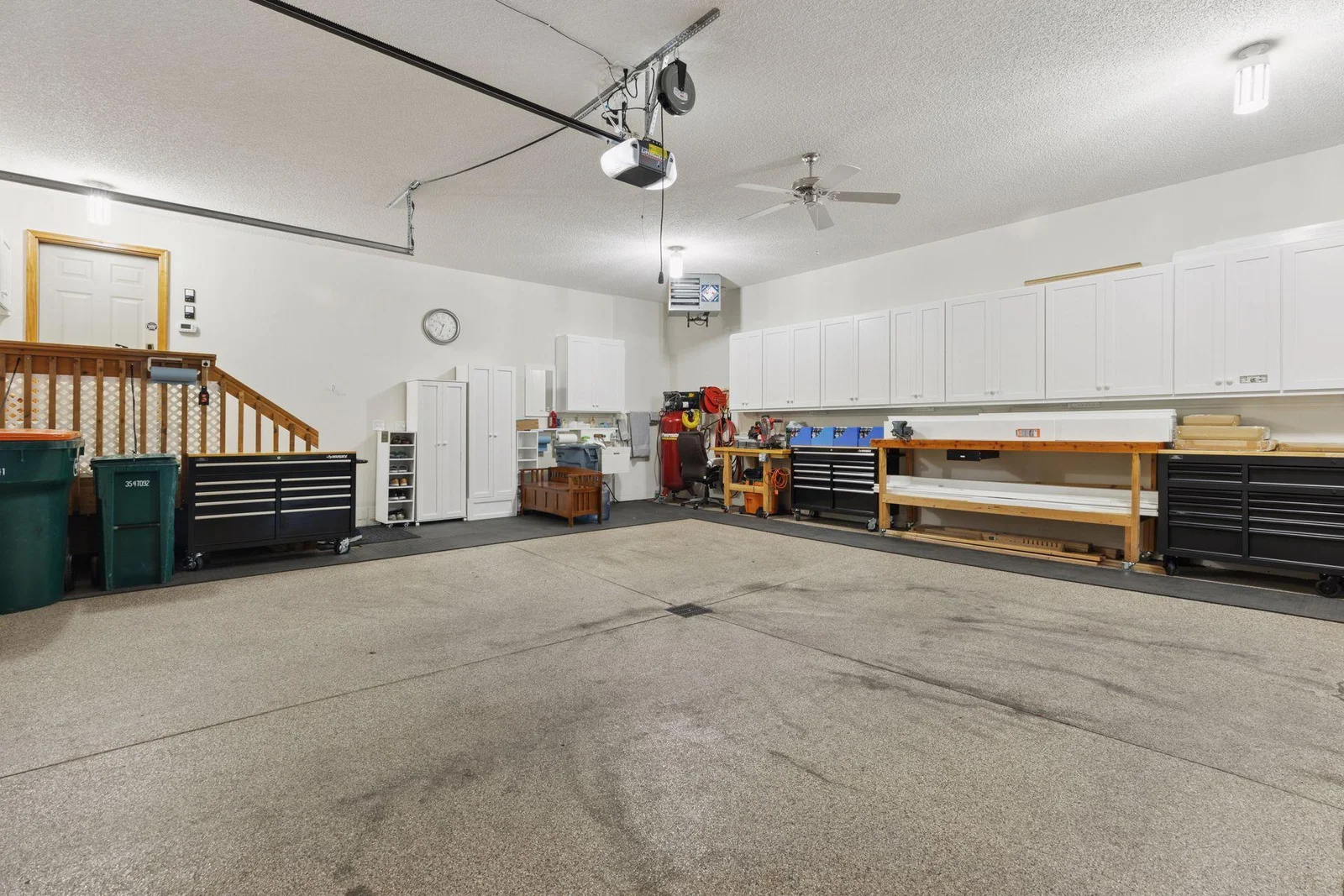Heated 3+ garage with floor drains, LED lighting, sink & walls of cabinets!  Amazing