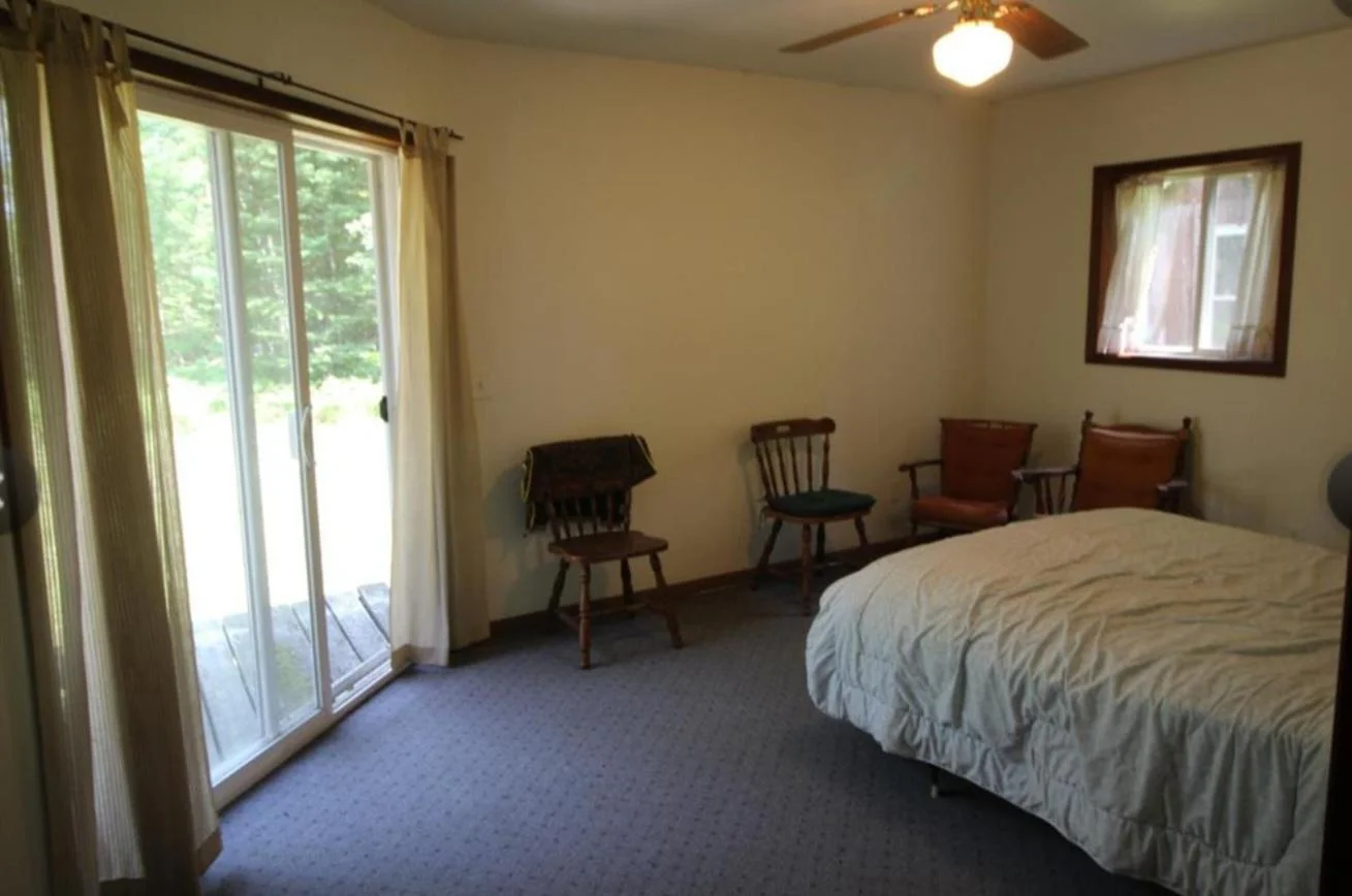 Primary bedroom with patio door and walk in closet.