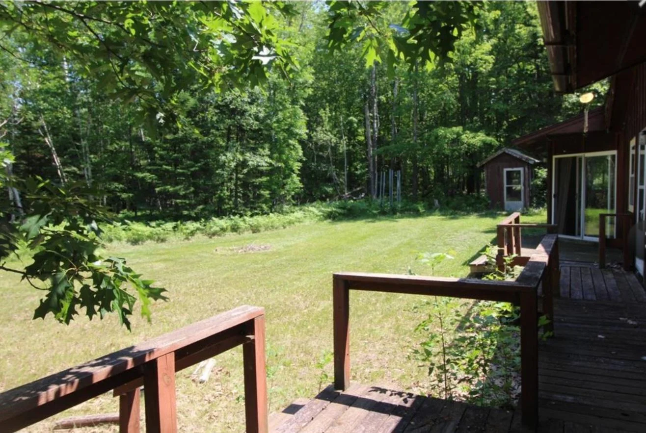 View from deck to the side yard, fish cleaning house in view to the right