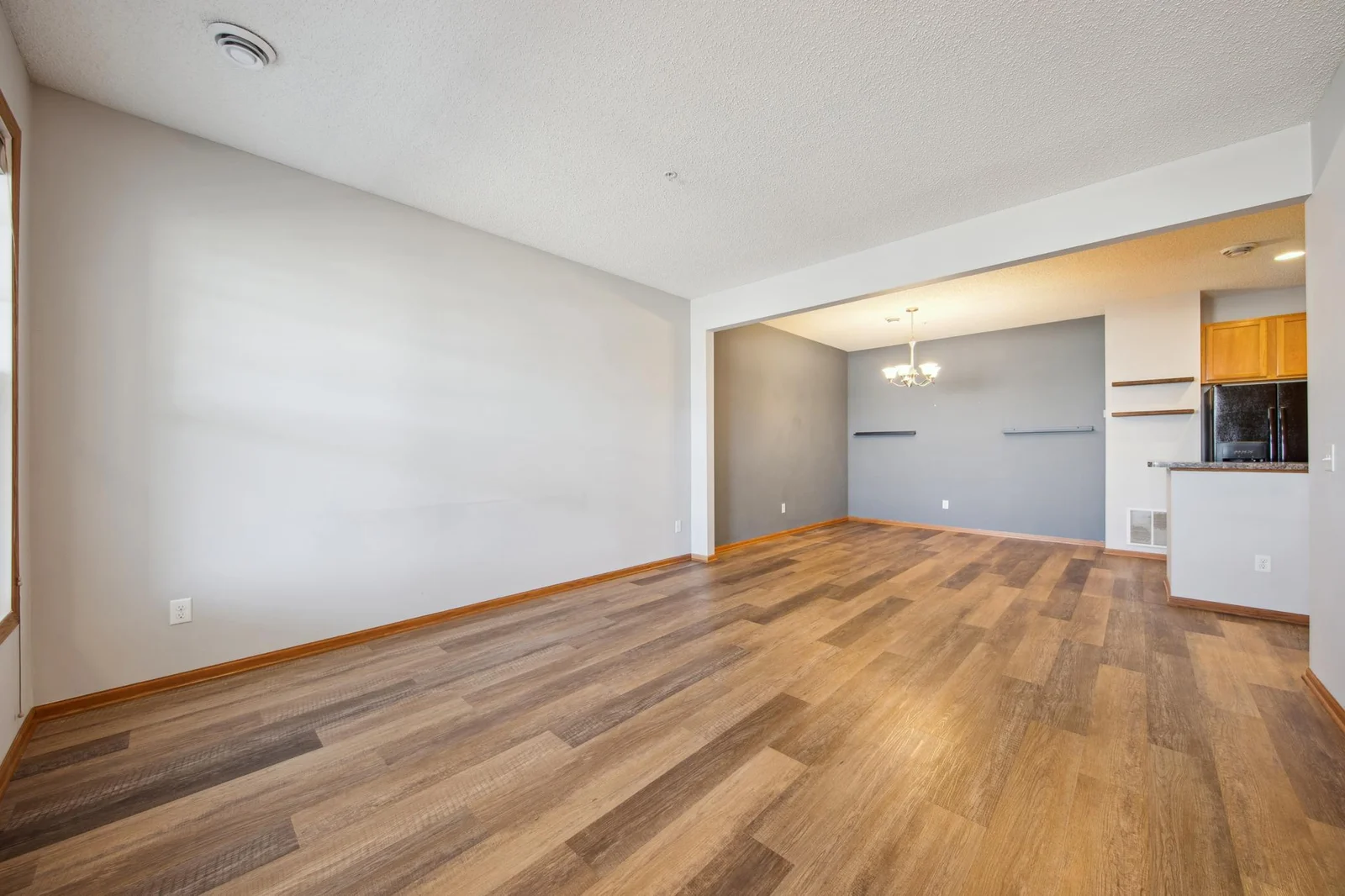Spacious main level living room and dining room with newer vinyl plank flooring