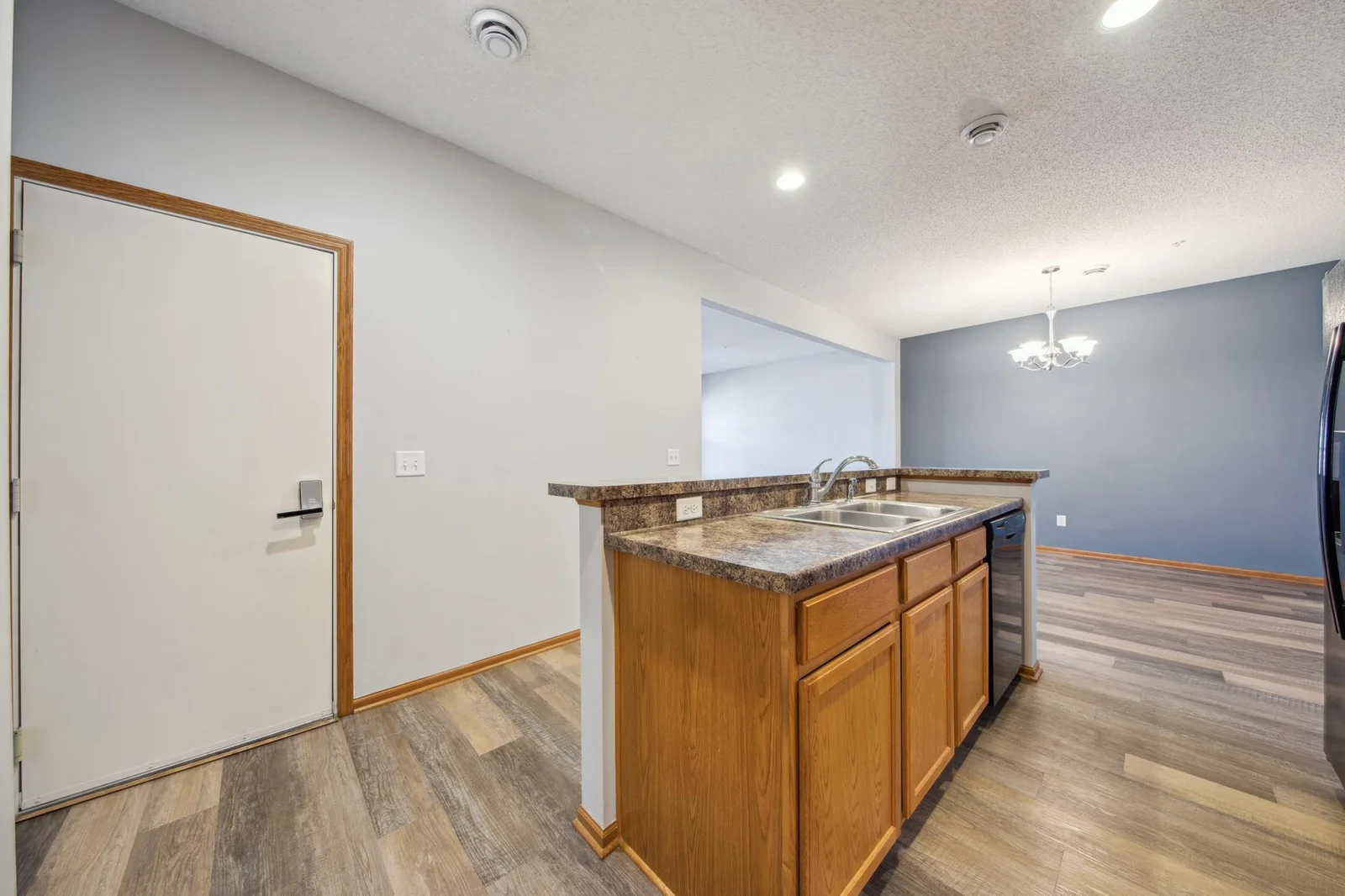 Main level kitchen with matching appliances and walk-out access to the garage.