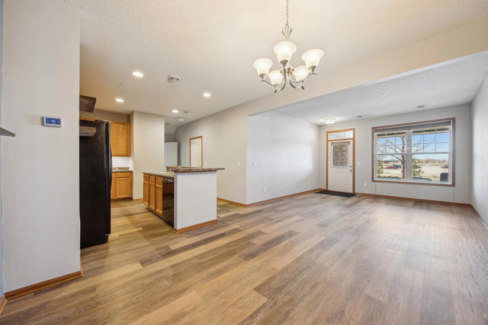 Bright and open main level floor plan featuring a generous living room, dining area, and a well-equipped kitchen