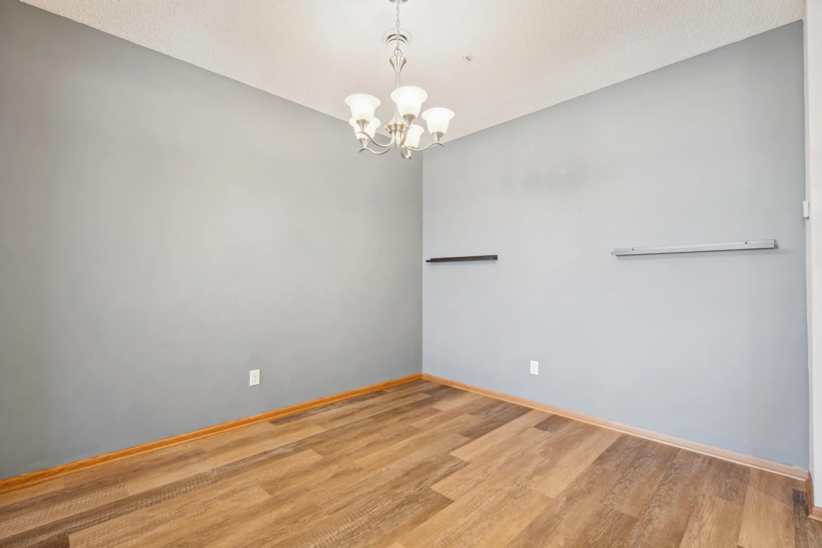Main level dining room with an elegant chandelier and ample entertaining room