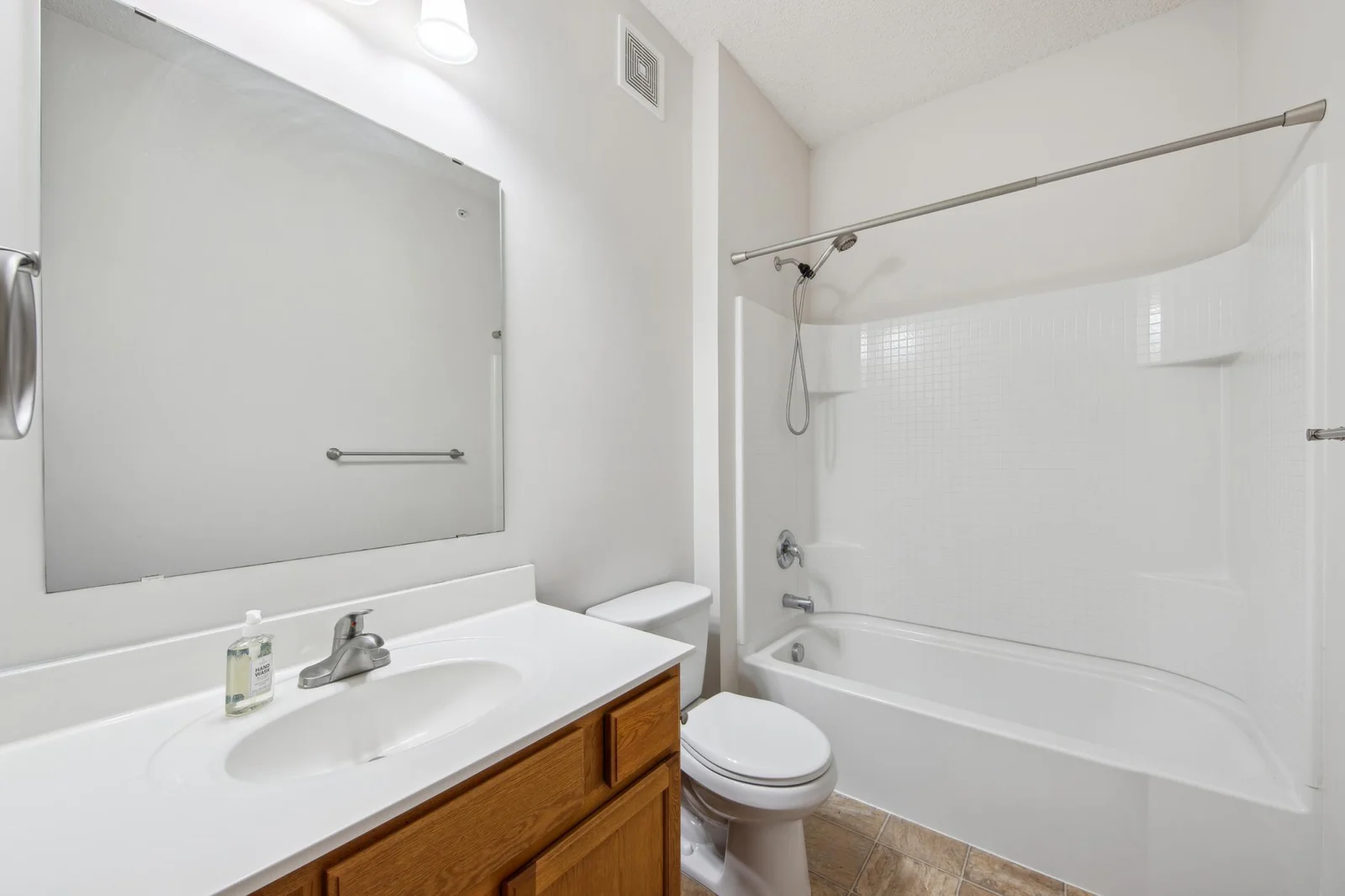 Upper level full bathroom with a spacious vanity