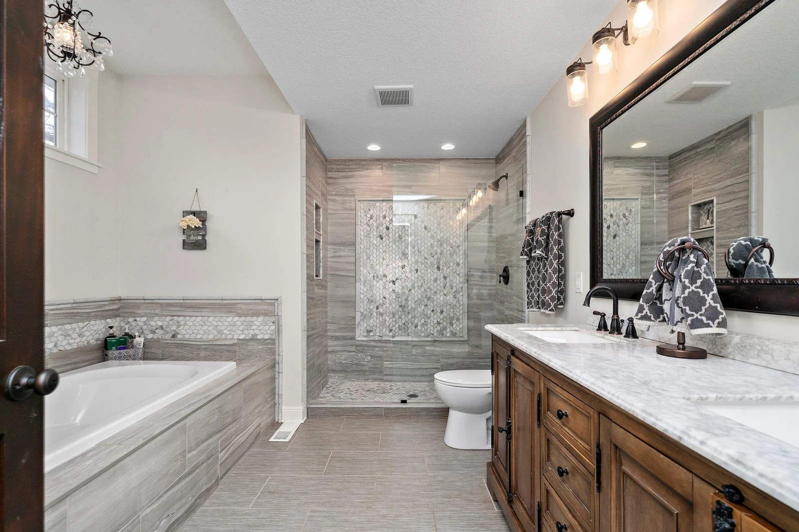Gorgeous primary bathroom with dual sink vanity, step-in shower, huge soaking tub, and heated floor!