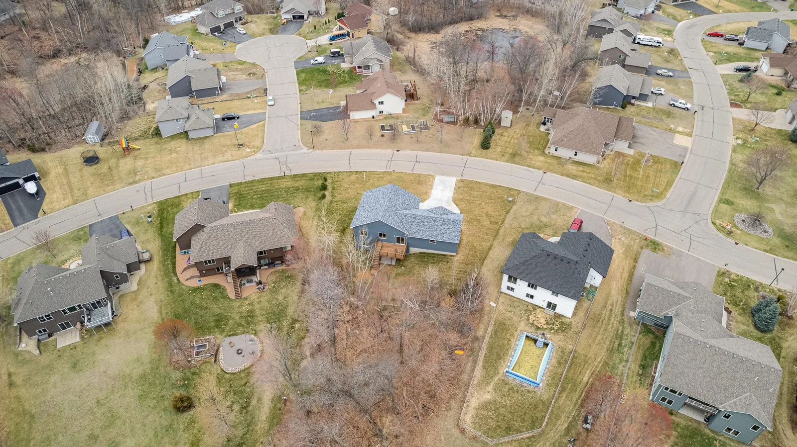 Arial view of the home and wooded lot.
