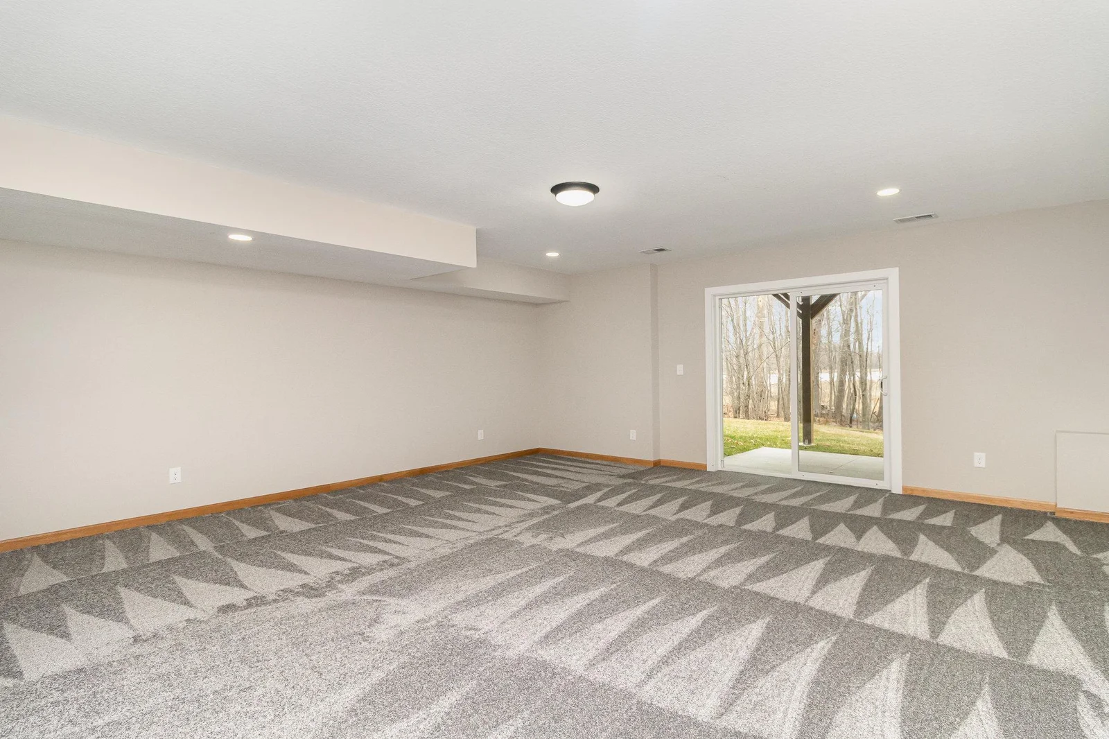 Spacious lower level family room walks out to patio, deck and backyard which leads to Elms Lake.