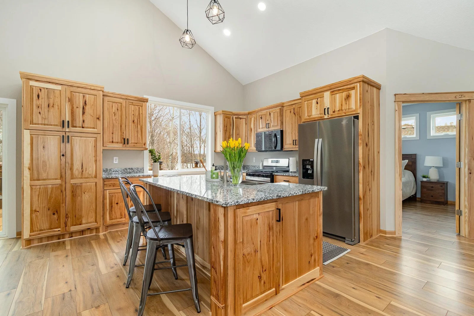 Beautiful Hickory Cabinets and Quartz countertops.