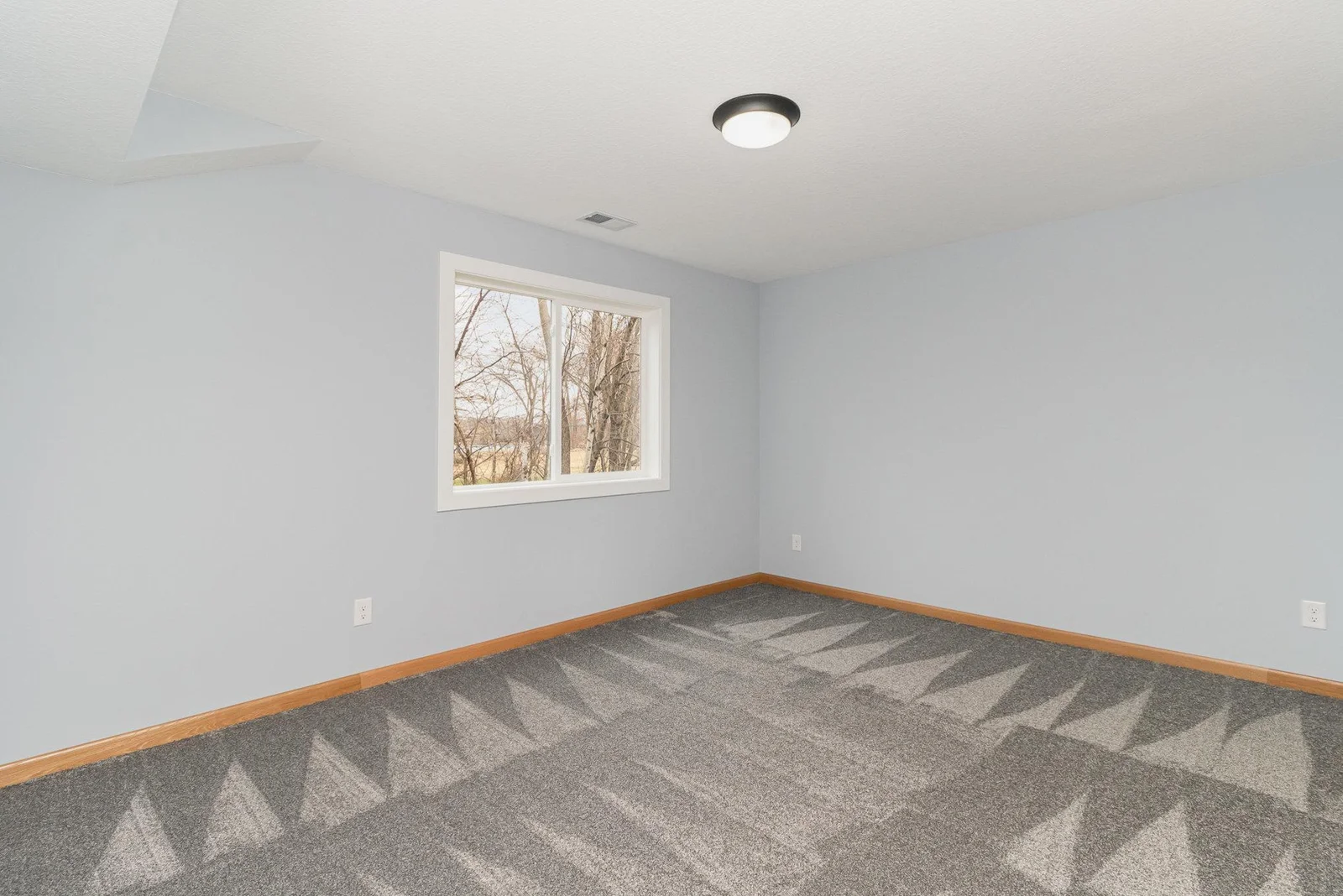 Bedroom #2 offers views of wooded backyard and lake.