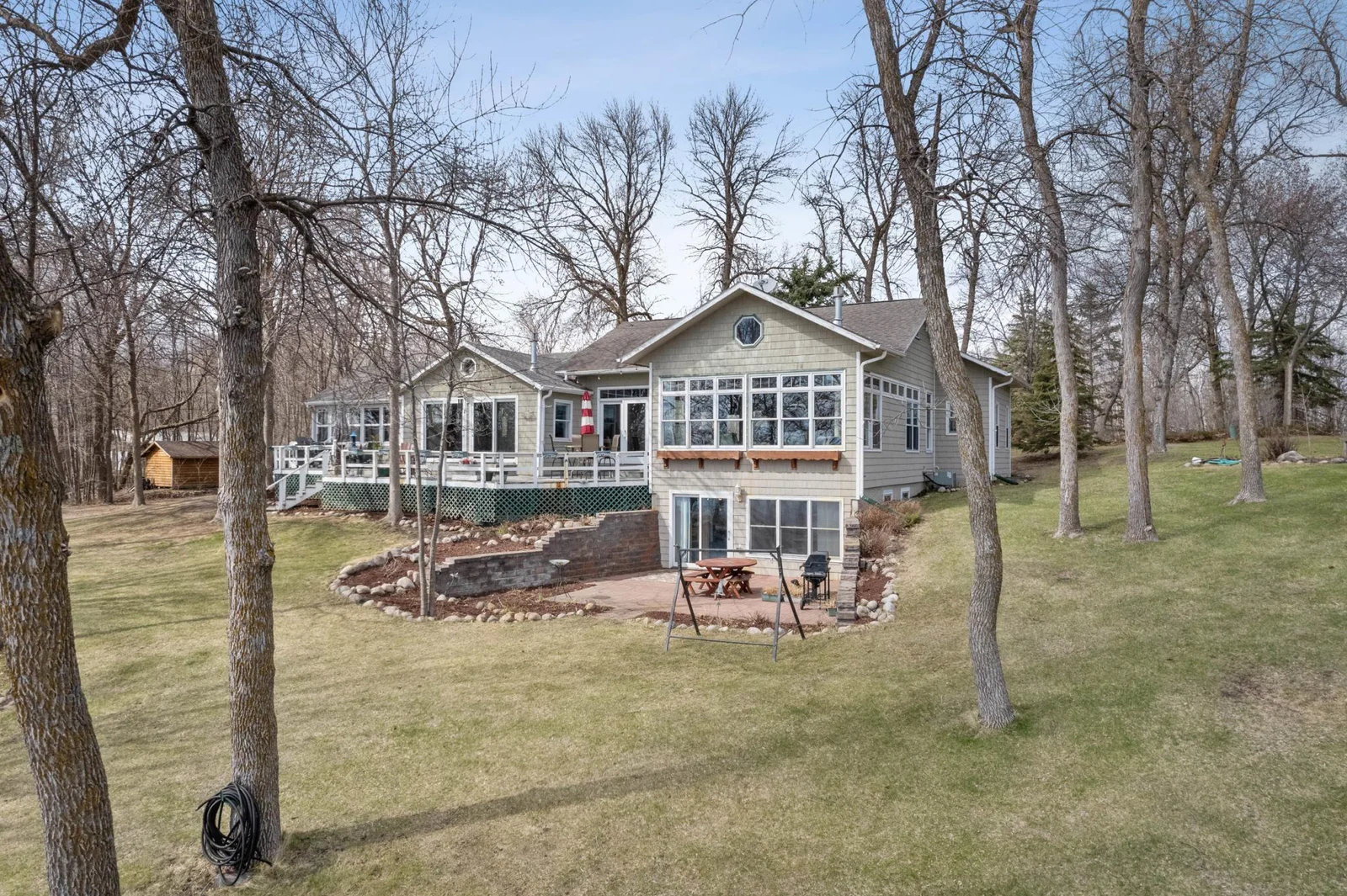 Stained cedar siding w/Pella windows & patio doors