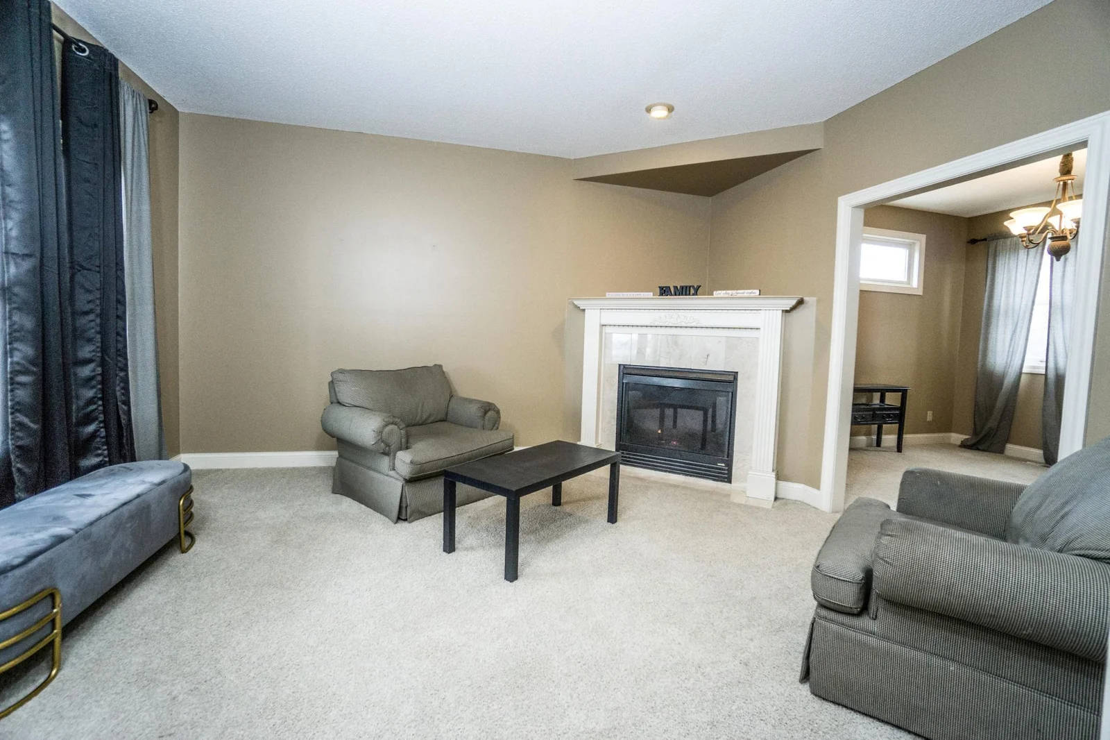 Living room with gas fireplace & views of School Lake..
