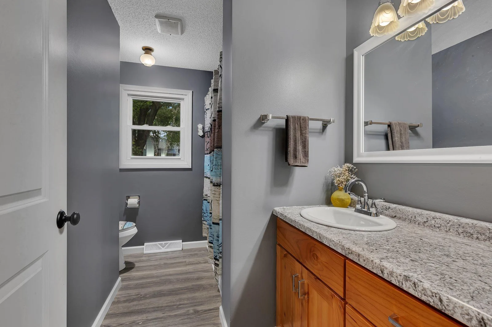 Full bathroom features updated vanity.