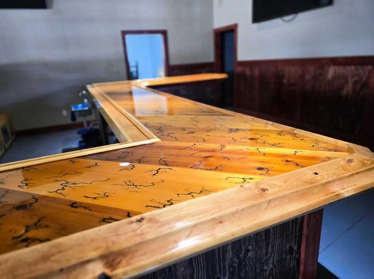 Another view of the stunning bar! The wood has been finished with many coats of polyurethane to protect its beauty for years to come.