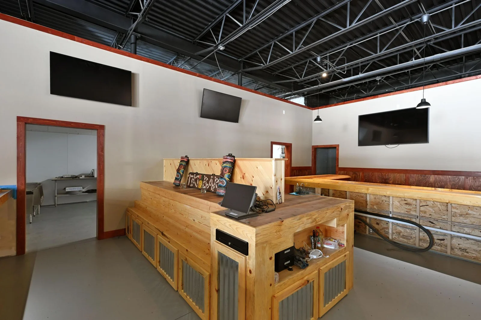 The bar island is ready for your service needs with hidden storage, tiered shelving to display products, built in power supply, shelving for organization and even built ins for point of sale systems.