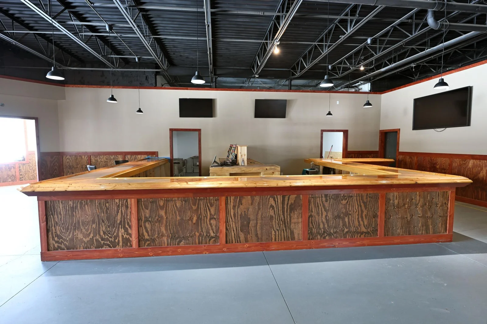 The spacious bar creates a welcoming interactive space that has enough room for over 50 guests to sit.