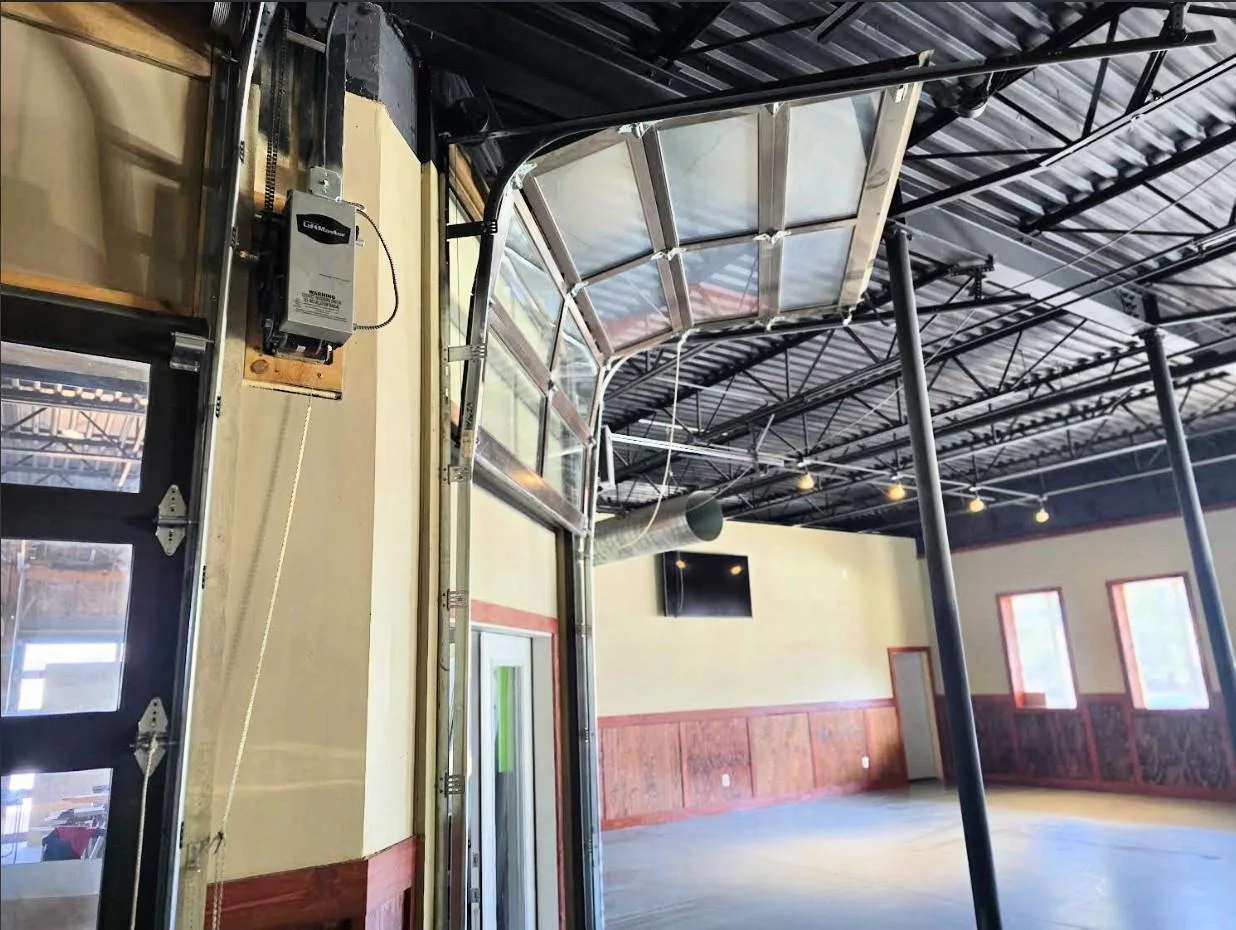 Close up view of glass garage doors, they can easily be operated manually but are also motorized as well for easy operation.