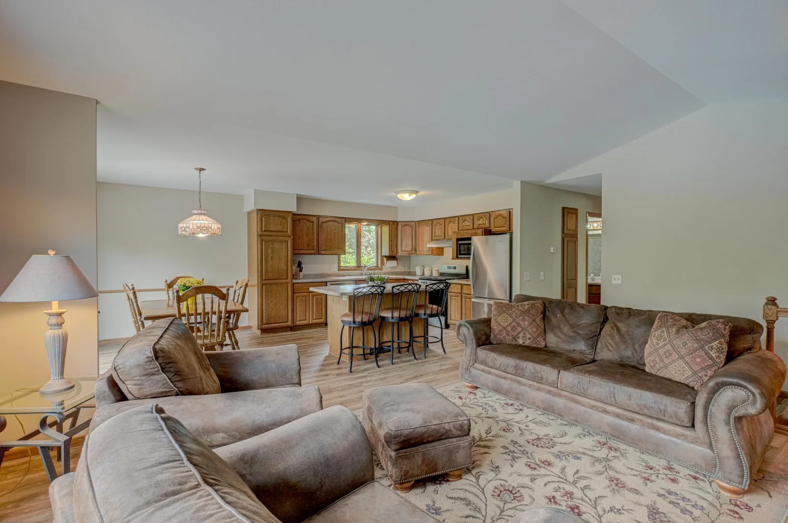 Step inside to a bright, open layout with high ceilings, wood floors, and Andersen windows throughout.