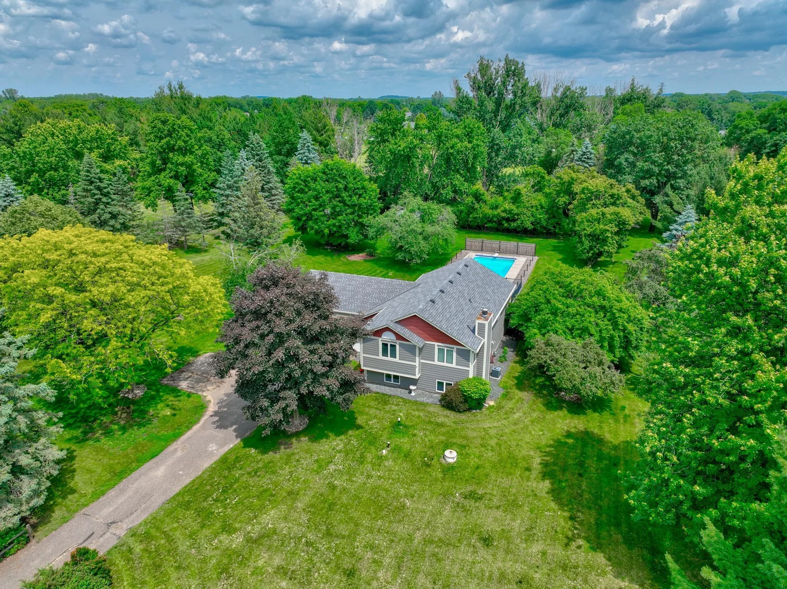 Backyard pool, spacious layout, and room for everyone—this charming Hudson home has it all!