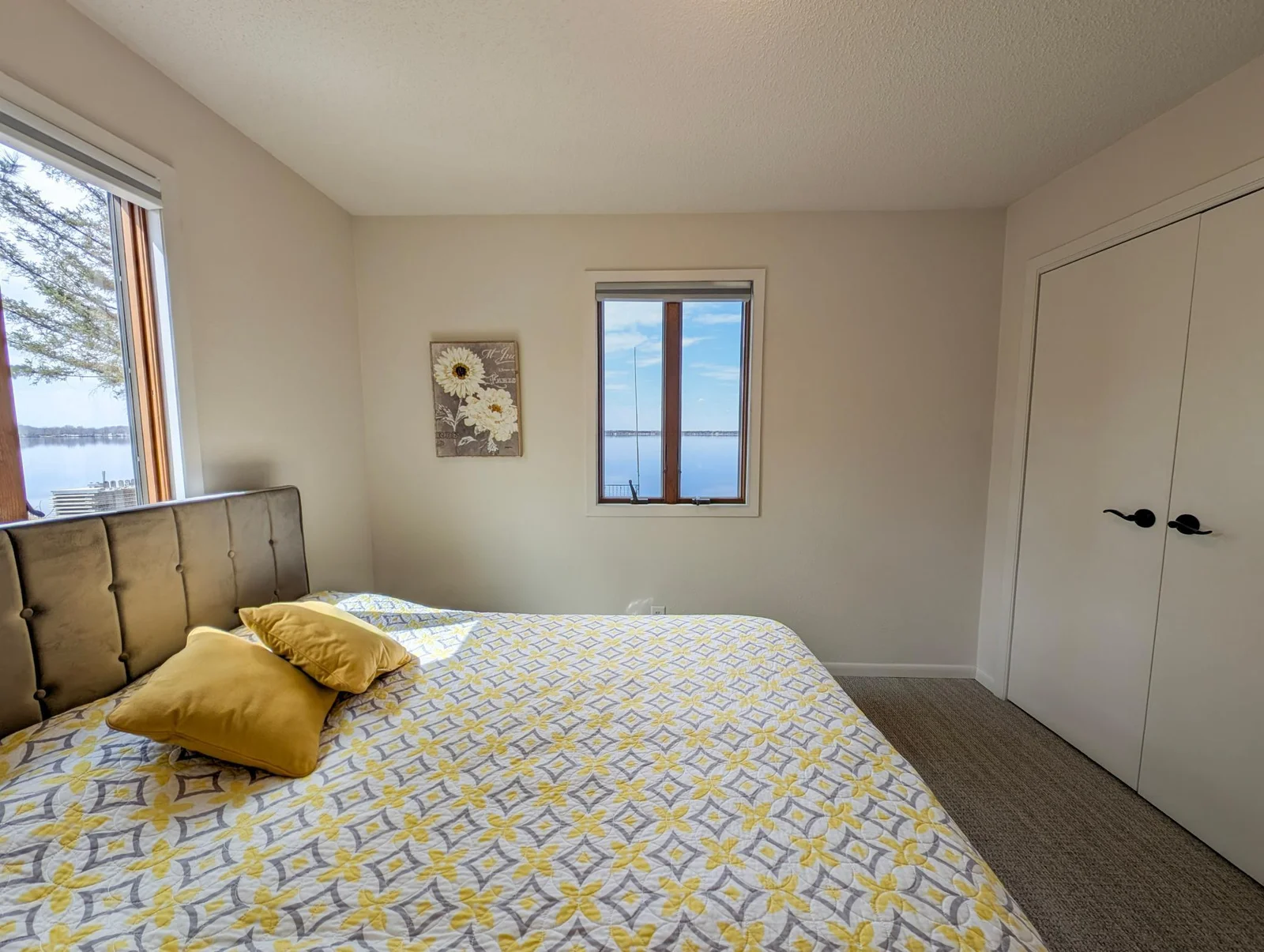 A lakeside dream—this bedroom offers direct views of Little Pine Lake and a cozy, serene atmosphere.