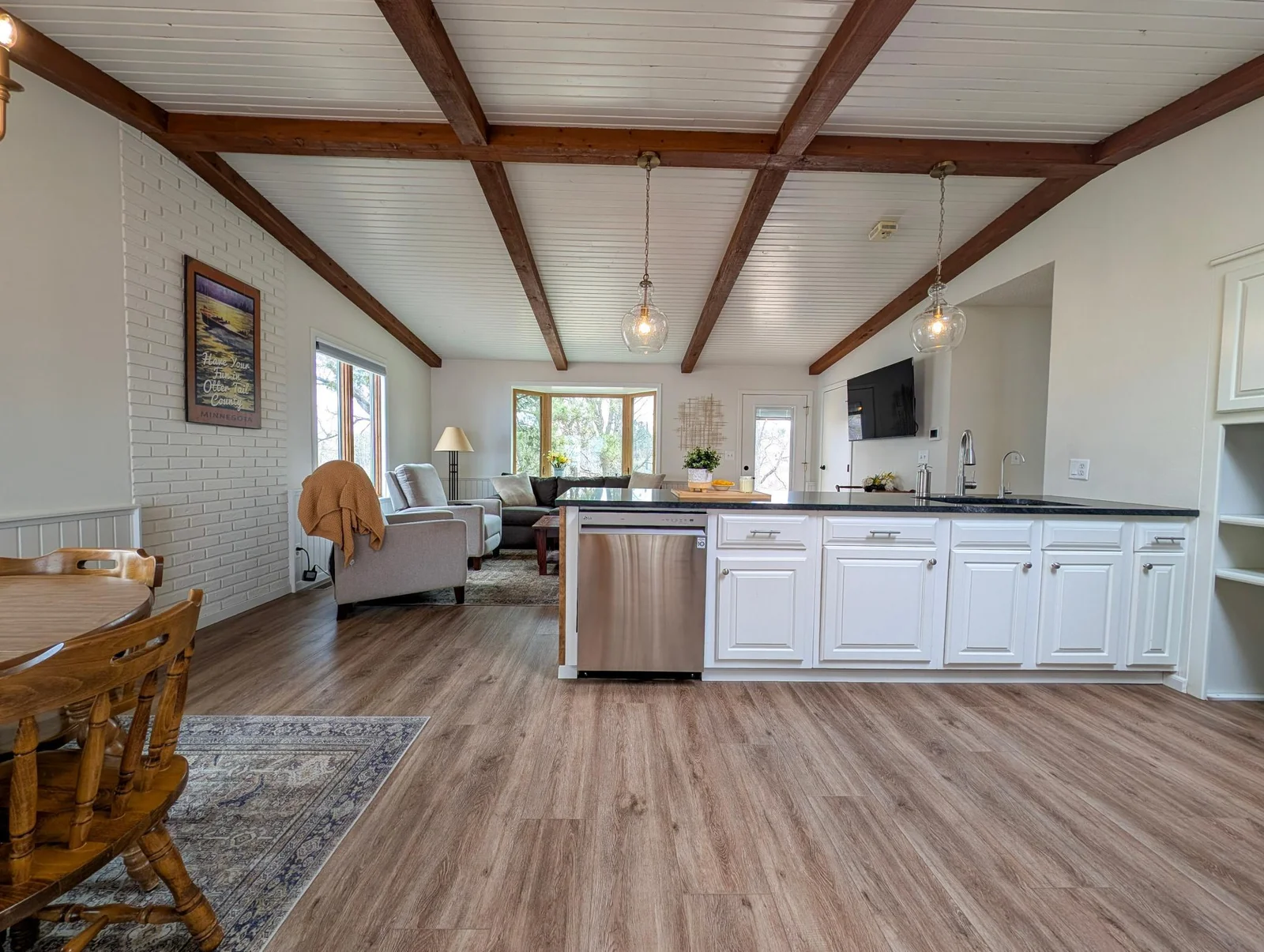 Stylish cabinetry, modern lighting, and plenty of prep space in this thoughtfully designed kitchen.