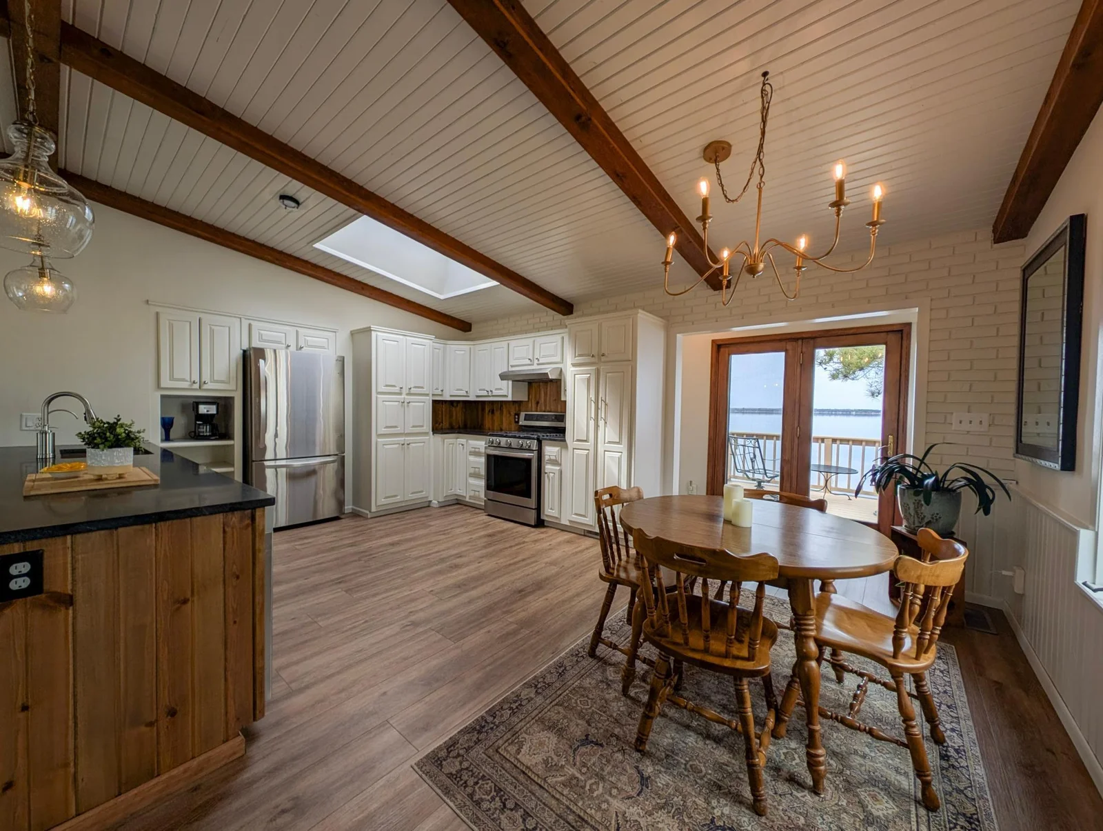 Large windows let in natural light, highlighting every elegant detail of this lakeside kitchen.