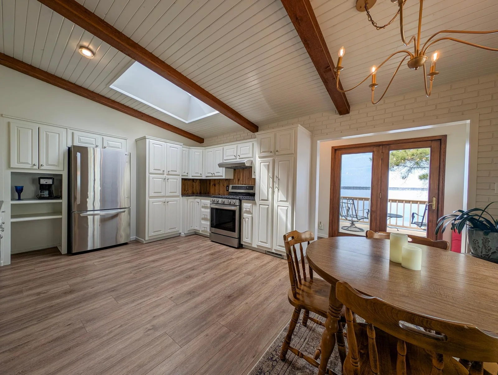 Host with ease in this beautiful lake home kitchen, featuring upgraded appliances and lake views.