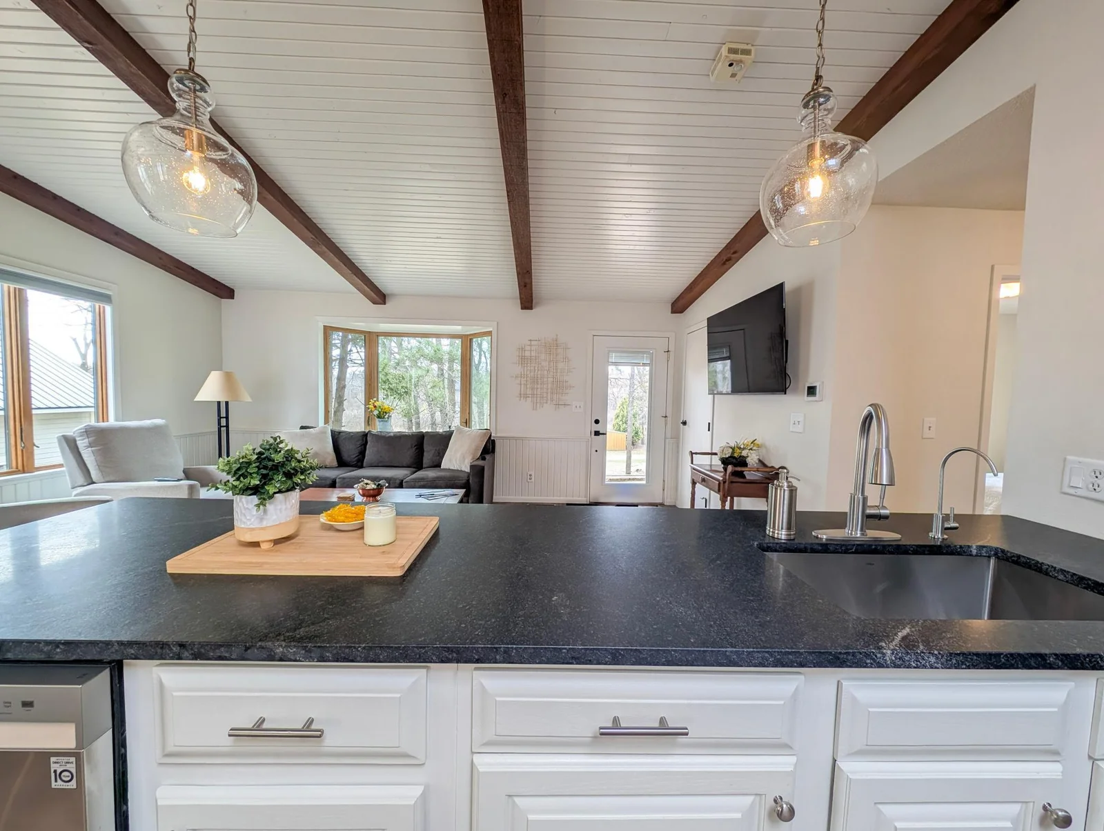 Stylish cabinetry, modern lighting, and plenty of prep space in this thoughtfully designed kitchen.