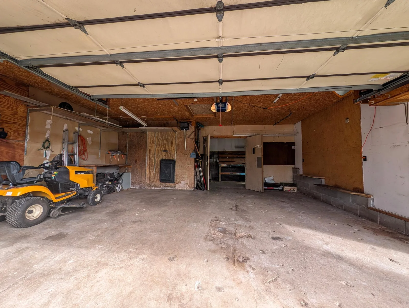 A two-stall detached garage includes a woodshop space.