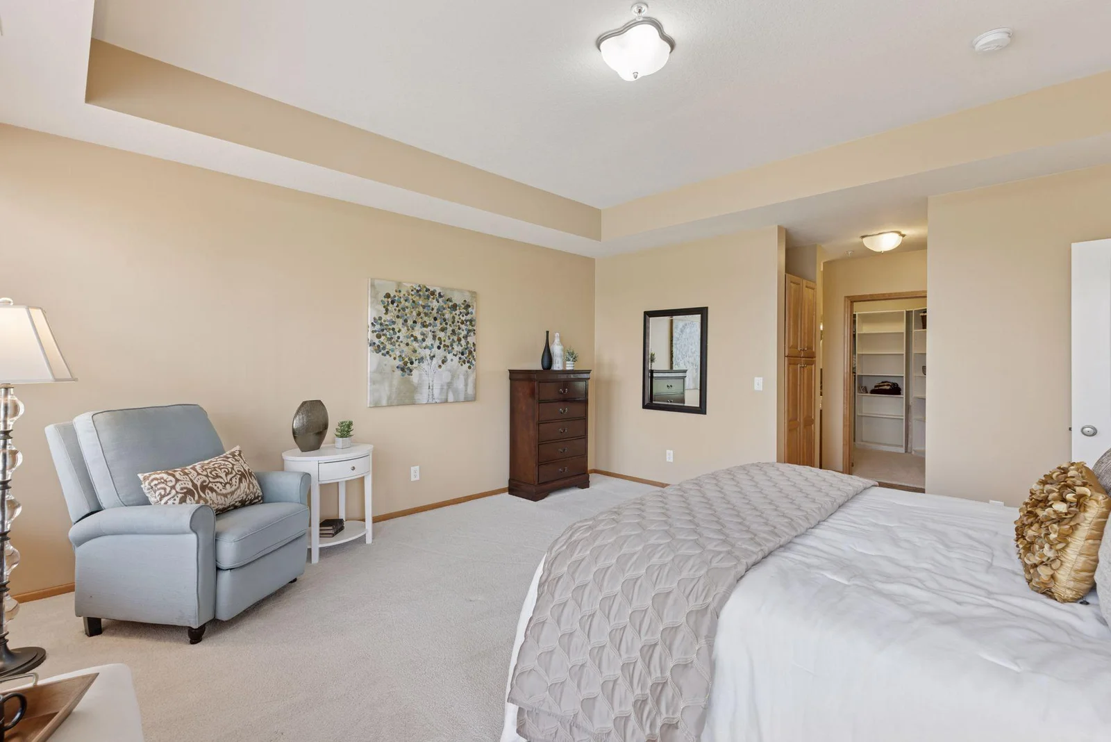 Spacious Primary bedroom opens into the private & luxurious bathroom & walk-in closet.