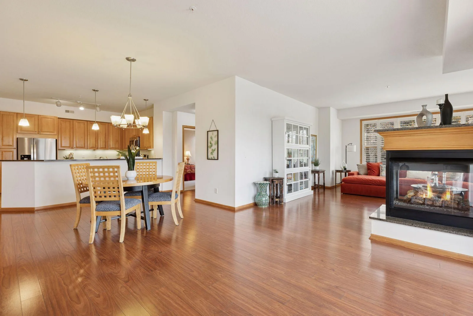 Open floor plan, High ceilings, 3-sided Fireplace, and gleaming luxury plank flooring. A beautiful place to relax and plenty of room to entertain.