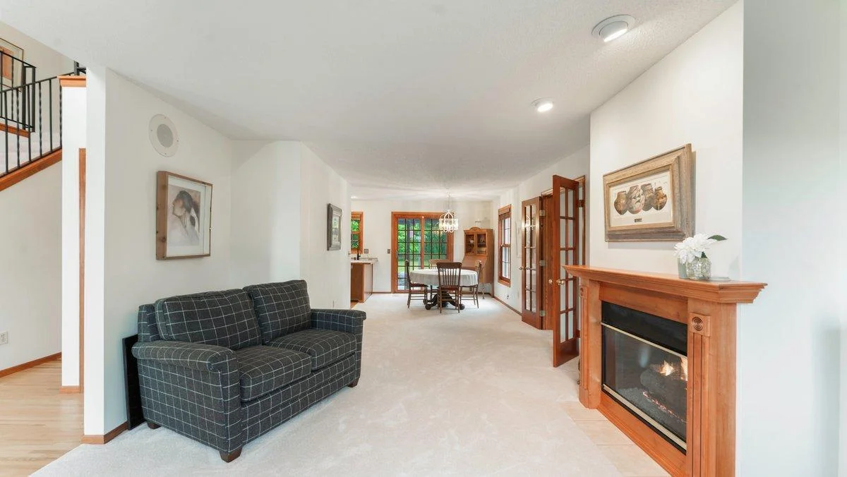 Main floor living room with 2 sided fireplace.