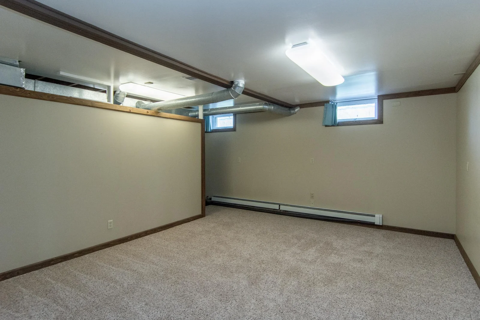 Bedroom in lower level and new photo will be coming to show the recent egress window that was installed. This room has 2 north-facing windows and a carpeted floor.