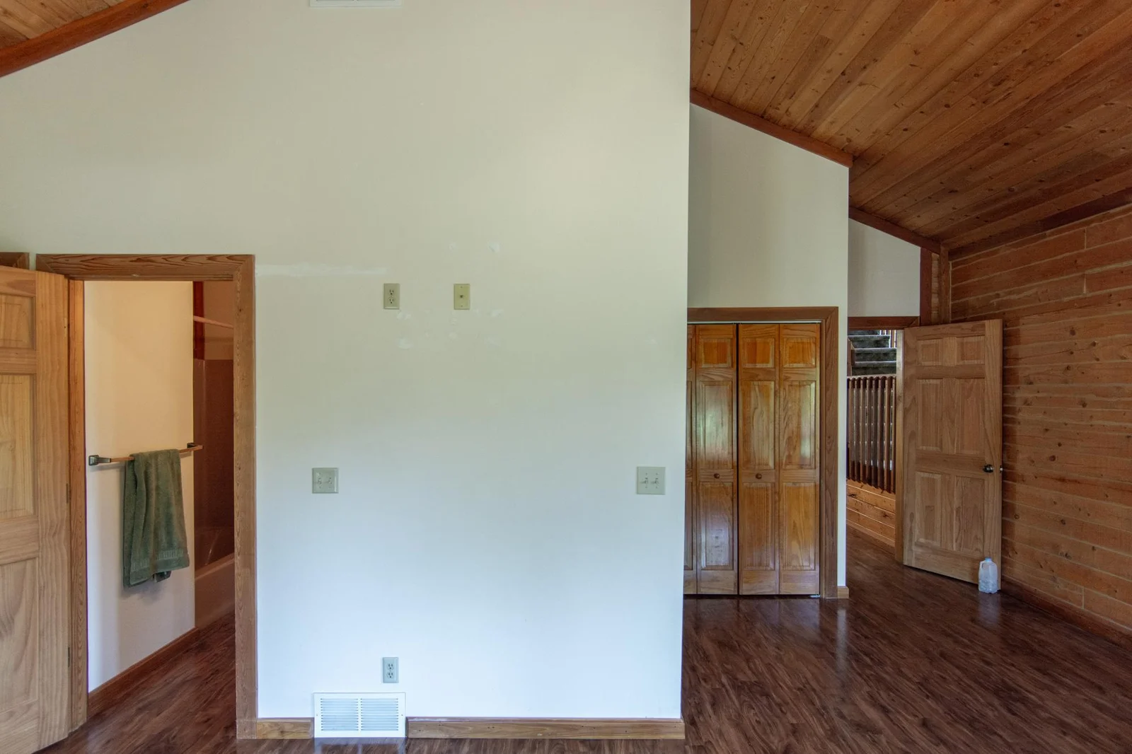 The primary bedroom has a vinyl floor, four closets with the largest measuring 2.5x8 ft., a ceiling fan, private full bathroom and windows facing east and south.