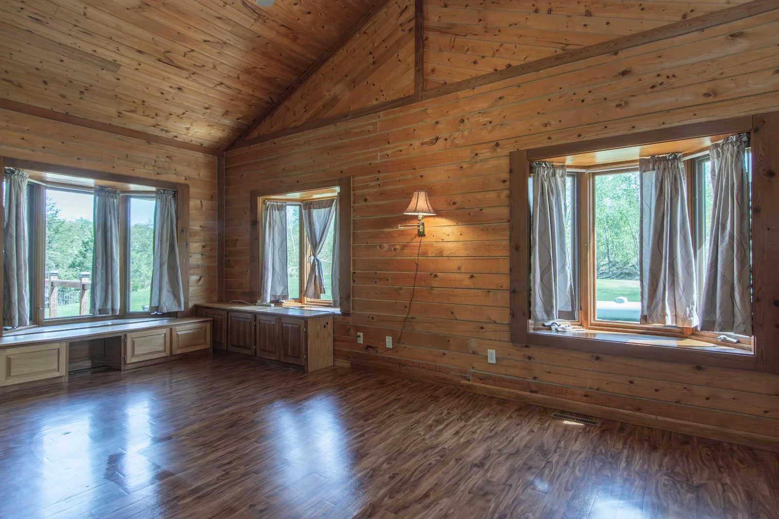The primary bedroom has a vinyl floor, four closets with the largest measuring 2.5x8 ft., a ceiling fan, private full bathroom and windows facing east and south.