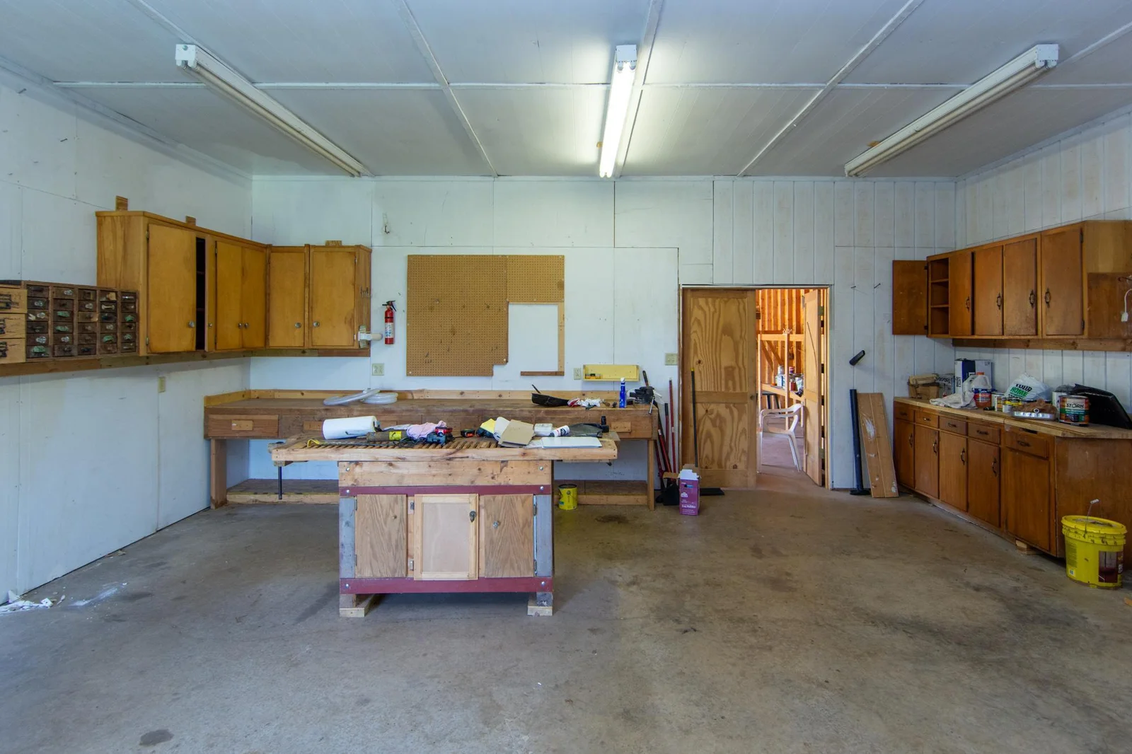 Heated workshop in the garage. Cabinets will stay.