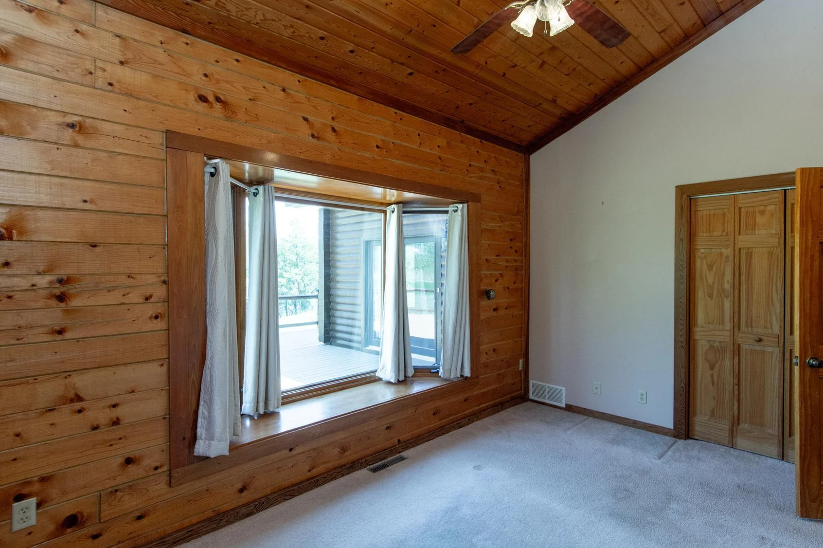 Bedroom 2 has a carpeted floor, a ceiling fan, a 2x4.5 ft. closet, and windows facing east and north.