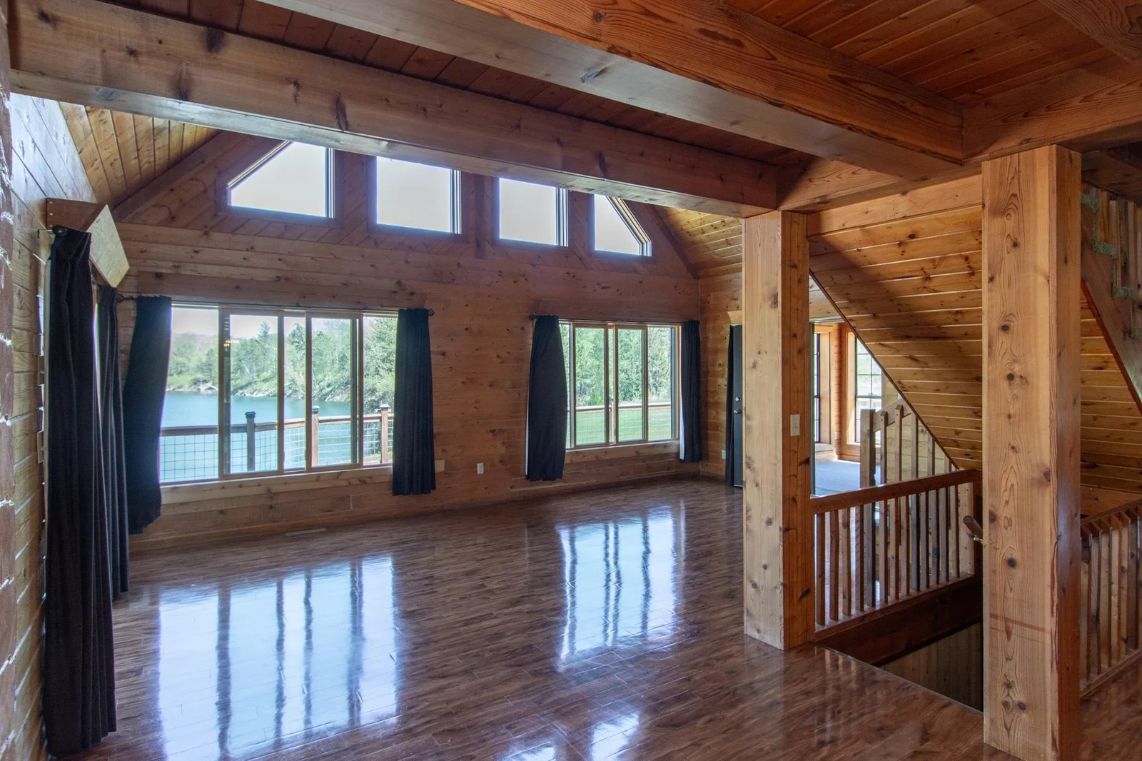 The Living Room has a vinyl floor, a ceiling fan, a 2x4 ft. closet, six east-facing windows, a north-facing patio door with deck access, and a south-facing door to the 3-season porch.