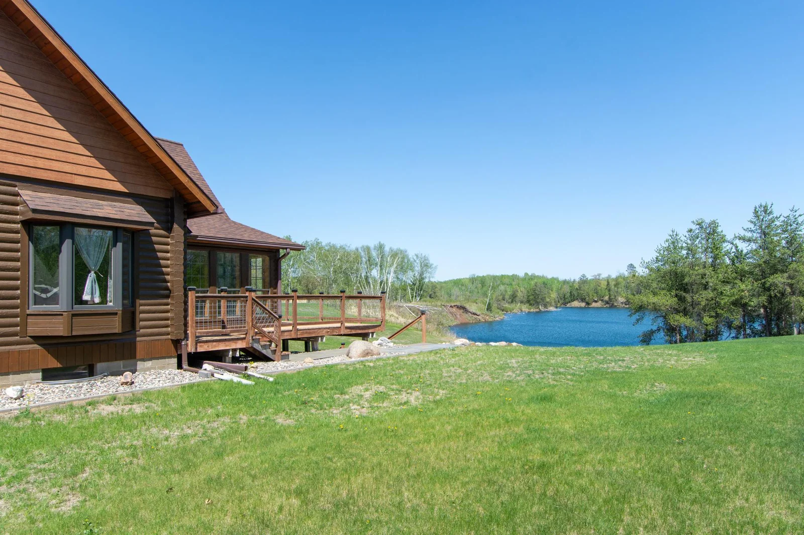 A view of the home, yard, and mine pit lake from the south side of the home.